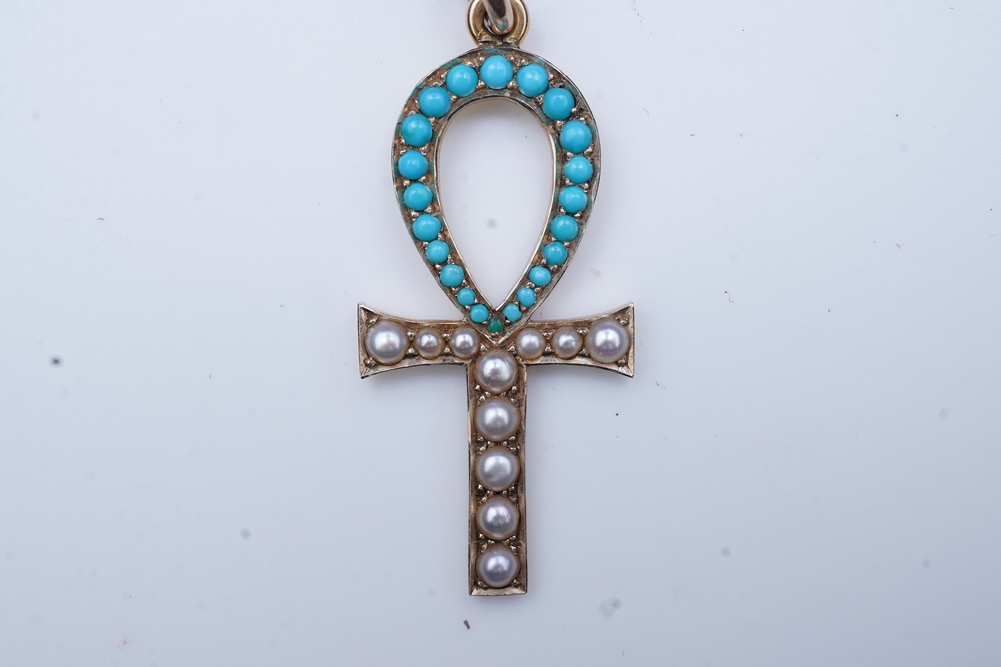 An Edwardian Egyptian revival turquoise and pearl pendant, early 20th century